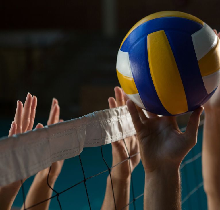 Cropped hands of players practicing volleyball at court